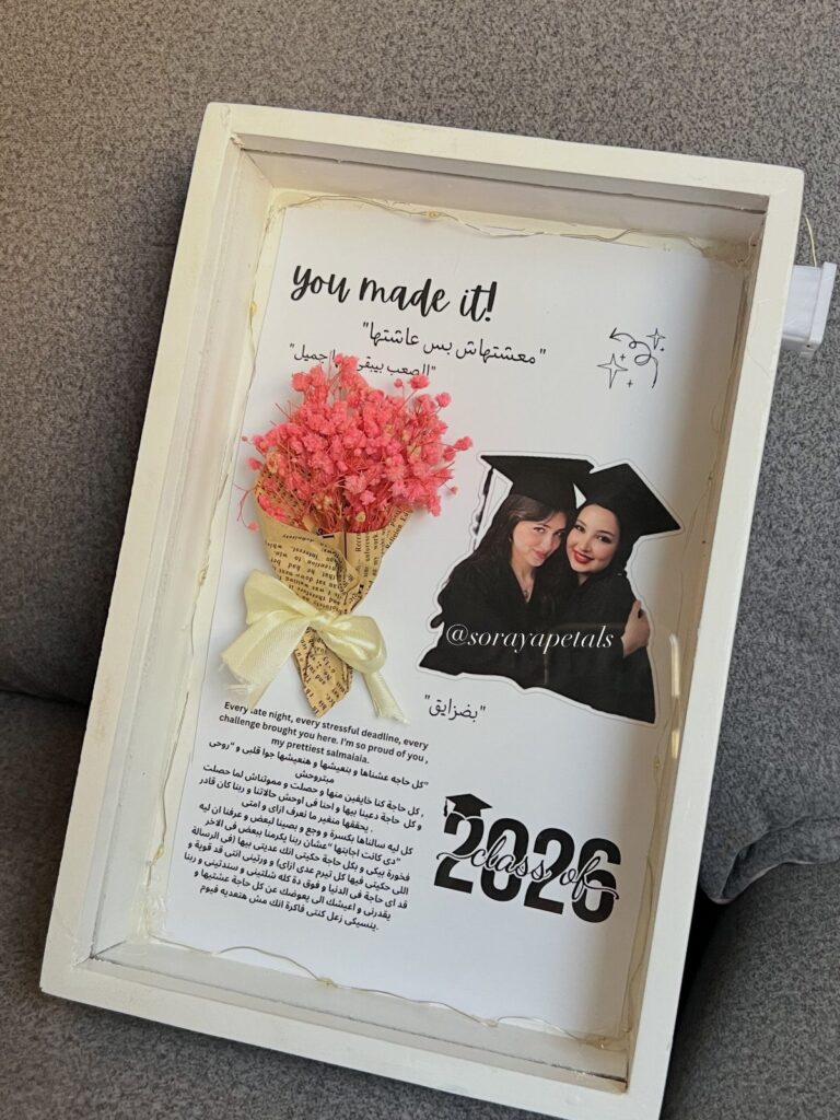 Graduation keepsake shadow box with photo of friends, pink flowers, and Class of 2026