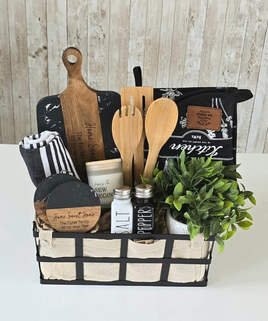 Housewarming gift basket with wooden kitchen tools, a candle, and a small plant.