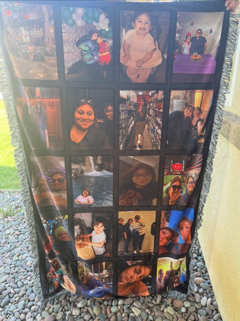Personalized fleece blanket with a grid of family photos held over grey pebbles.