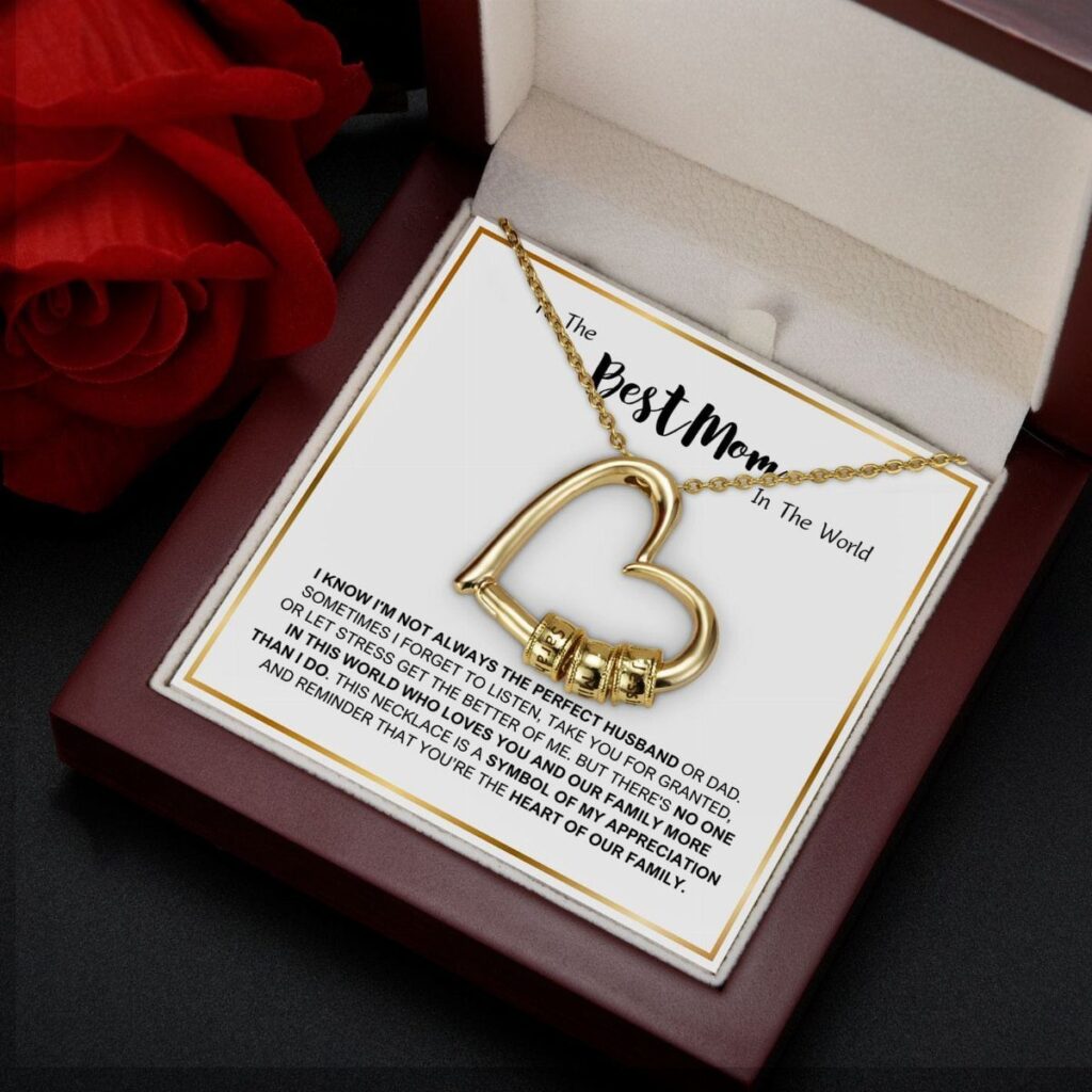 Gold heart-shaped necklace in a jewelry box with a Best Mom card