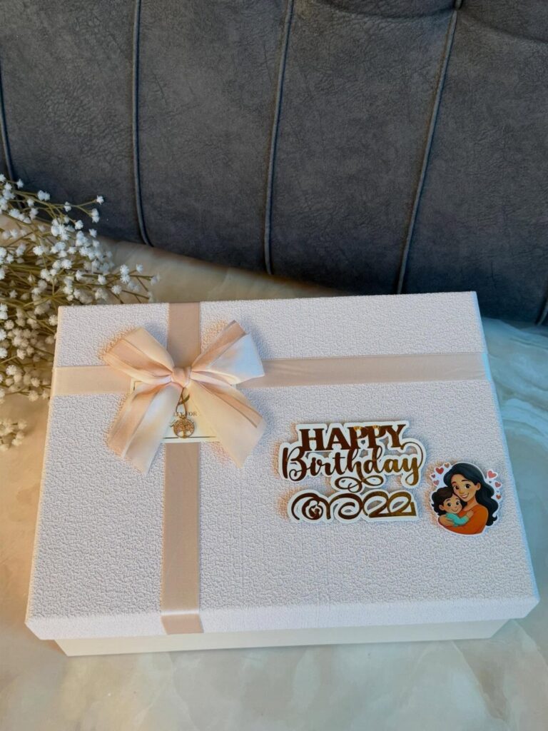 White glittery birthday gift box with champagne ribbon and mother-child illustration